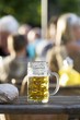 A litre of beer (partly drunk) standing on a table