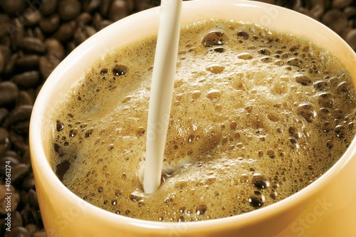 Photo: Pouring milk into a cup of coffee Pouring milk into a cup of coffee