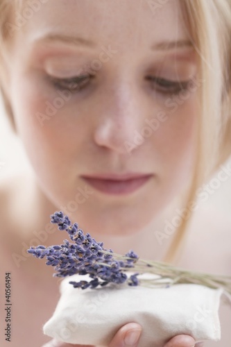 Photo: Young woman with lavender pillow Young woman with lavender pillow