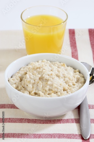 Photo: Porridge in a bowl and a glass of orange juice Porridge in a bowl and a glass of orange juice