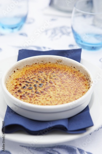 Photo: Crème brûlée on a plate with napkin Crème brûlée on a plate with napkin