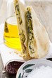 Pieces of spinach & ricotta pie beside olive oil bottle, salt