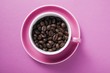 Coffee beans in pink coffee cup