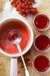 Redcurrant jelly in a pan and in jam jars