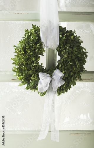 Photo: Christmassy door wreath of box with white bow Christmassy door wreath of box with white bow