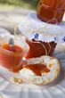 Rose hip jam in jars and on bread roll