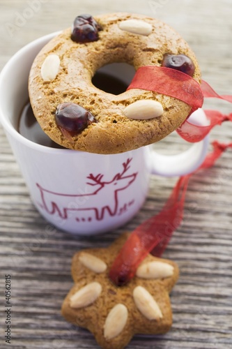 Photo: Gingerbread tree ornaments on and beside a cup Gingerbread tree ornaments on and beside a cup