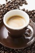 Cup of espresso on coffee beans
