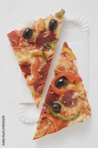 Photo: Slice of pepperoni pizza with peppers and olives (halved) Slice of pepperoni pizza with peppers and olives (halved)