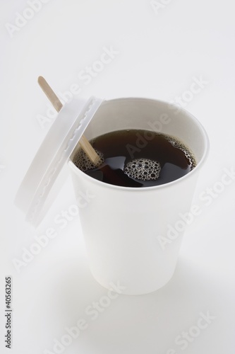 Photo: Black coffee in paper cup with wooden stirrer Black coffee in paper cup with wooden stirrer