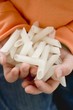 Child's hands holding penne