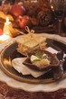 Festive place-setting with crackers & butter for Thanksgiving
