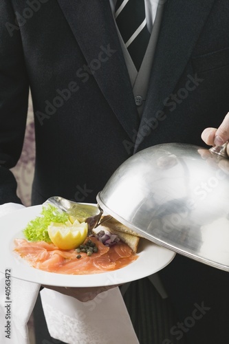 Photo: Butler serving smoked salmon with toast Butler serving smoked salmon with toast