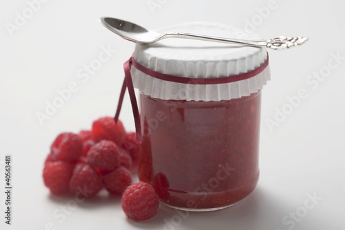 Photo: Jar of raspberry jam with spoon, fresh raspberries beside it Jar of raspberry jam with spoon, fresh raspberries beside it