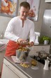 Man peeling potatoes in a kitchen