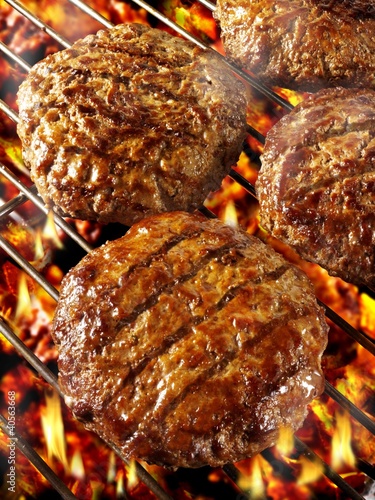 Photo: Burgers on barbecue rack Burgers on barbecue rack