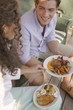 Young couple at a barbecue out of doors