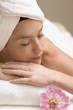 Woman lying down, resting on white towel