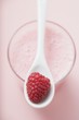 Raspberry shake with spoon & fresh raspberry (overhead view)