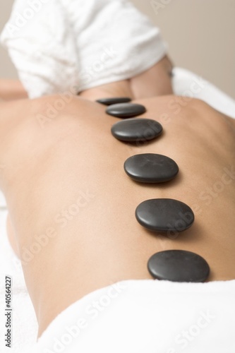Photo: Woman having LaStone Therapy (healing therapy using stones) Woman having LaStone Therapy (healing therapy using stones)