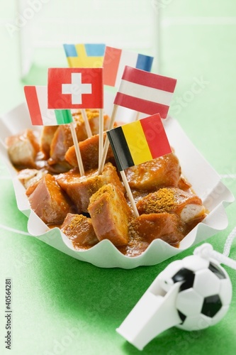 Photo: Currywurst with various flags in paper dish Currywurst with various flags in paper dish