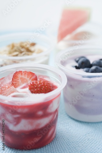 Photo: Four yoghurts with berries, cereal and watermelon Four yoghurts with berries, cereal and watermelon