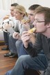 Friends with pizza and football watching