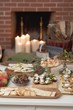 Assorted appetisers on table in front of fireplace (Christmas)