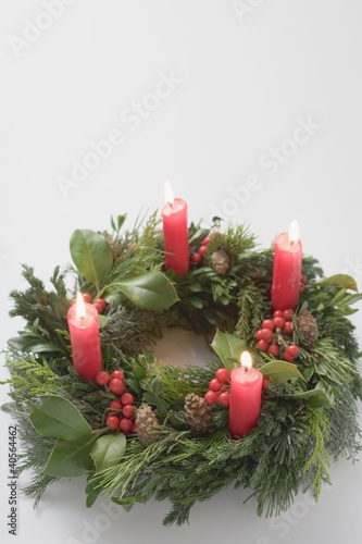 Photo: Advent wreath with four burning candles Advent wreath with four burning candles