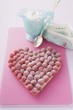 Raspberry tart with icing sugar, whipped cream in small jug