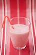 Strawberry milk in glass with straw