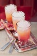 Three fruity drinks with orange juice & pomegranate
