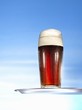 Glass of malt beer on tray