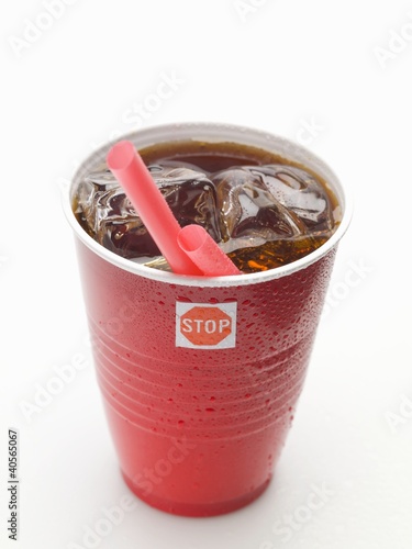 Photo: Cola with ice cubes and straw in plastic cup Cola with ice cubes and straw in plastic cup