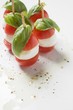 Tomatoes, mozzarella and basil on cocktail sticks