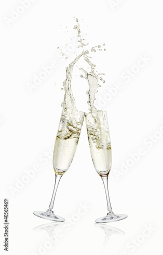 Photo: Glasses of sparkling wine clinking together Glasses of sparkling wine clinking together