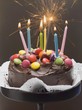 Chocolate cake with coloured chocolate beans and candles