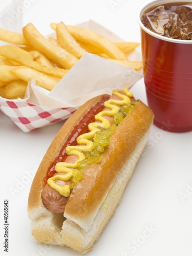 Photo: A hot dog, a portion of chips and a plastic cup of cola A hot dog, a portion of chips and a plastic cup of cola