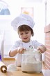 Foto: Little girl with flour and rolling pin Little girl with flour and rolling pin