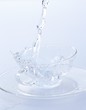 Pouring water into a glass cup