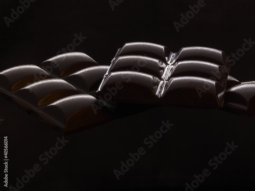 Photo: Bars of chocolate with black background Bars of chocolate with black background