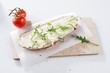 Bread and butter with rocket on a board
