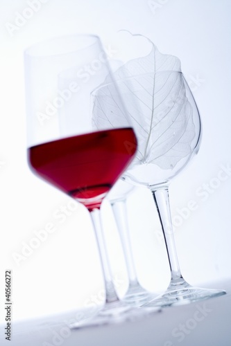 Photo: Glass of red wine and empty wine glasses Glass of red wine and empty wine glasses