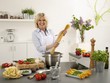 Woman laughing with spaghetti in her hands