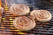 Coiled sausages on barbecue rack
