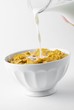 Pouring milk on cornflakes