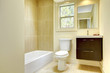 Photo: New modern yellow bathroom with beige tiles. New modern yellow bathroom with beige tiles.