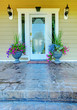 Green house with white door entrance.