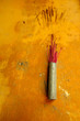 Incense in Holder Against Yellow Wall