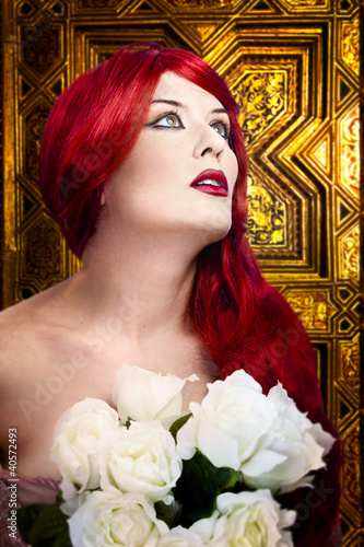 Photo: Gothic woman, faith concept. Red hair beautiful girl over medie Gothic woman, faith concept. Red hair beautiful girl over medie